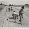 Family walking on highway, five children. Started from Ioabel, Oklahoma. Bound for Krebs, Oklahoma. Pittsburg County, Oklahoma. In 1936 the father farmed on thirds and fourths at Eagleton, McCurtain County, Oklahoma