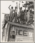 Colored boys playing on top of Coca Cola stand. Little Rock, Arkansas
