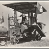 Combine harvester in California. Wheat field. San Joaquin Valley