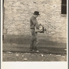 Cotton picker during strike carrying his Farm Security Administration grant of food and necessities from warehouse to Farm Security Administration Shafter camp for migrants, where he lives with his family. Bakersfield, California