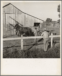 Farm Security Administration rural rehabilitation client, Tulare County, California, consulting with county supervisor. He and his family of seven were on relief. He had lost his arm on a construction project