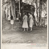 Morning mail at the Mineral King cooperative farm, Farm Security Administration, Tulare County, California. Old ranch house, California type, in the background. Buildings will be replaced by modern structures suitable to community farming