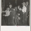 The children crowd and push to reach refreshments at Halloween party. Shafter migrant Camp, California