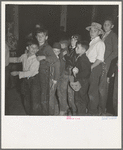 The children crowd and push to reach refreshments at Halloween party. Shafter migrant Camp, California
