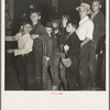 The children crowd and push to reach refreshments at Halloween party. Shafter migrant Camp, California