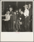 The children crowd and push to reach refreshments at Halloween party. Shafter migrant Camp, California