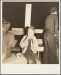 Hungry boy at the Halloween party for migrant workers. Shafter migrant camp, California