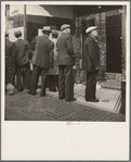 In front of the local paper of San Francisco's Chinatown Chinese read news of the surrender of Canton to the Japanese. Most of San Francisco's Chinese are Cantonese
