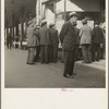 In front of the local paper of San Francisco's Chinatown Chinese read news of the surrender of Canton to the Japanese. Most of San Francisco's Chinese are Cantonese