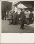In front of the local paper of San Francisco's Chinatown Chinese read news of the surrender of Canton to the Japanese. Most of San Francisco's Chinese are Cantonese