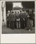 In front of the local paper of San Francisco's Chinatown Chinese read news of the surrender of Canton to the Japanese. Most of San Francisco's Chinese are Cantonese