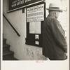 The street entrance to the Farm Security Administration office, Visalia, Tulare County, California. This farmer has come into town to discuss problems with the rural rehabilitation supervisor