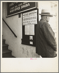 The street entrance to the Farm Security Administration office, Visalia, Tulare County, California. This farmer has come into town to discuss problems with the rural rehabilitation supervisor