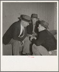 Camp manager, migratory worker, and visitor to the camp in discussion. Shafter camp for migrants, California