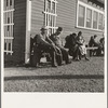 Lineup outside of Farm Security Administration grant office (relief to farm laborers) early in the morning, before the office has opened. Tulare, California