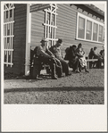 Lineup outside of Farm Security Administration grant office (relief to farm laborers) early in the morning, before the office has opened. Tulare, California