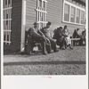 Lineup outside of Farm Security Administration grant office (relief to farm laborers) early in the morning, before the office has opened. Tulare, California