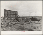 Three families camped on the plains along U.S. 99 in California