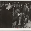 Street meeting at night in Mexican town outside of Shafter, California. Organizer for United Cannery Agricultural Packing and Allied Workers of America (Congress of Industrial Organizations-CIO) talks to mixed crowd. The strike failed