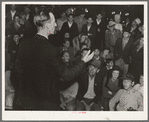 Street meeting at night in Mexican town outside of Shafter, California. Organizer for United Cannery Agricultural Packing and Allied Workers of America (Congress of Industrial Organizations-CIO) talks to mixed crowd. The strike failed