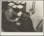 Night meeting in the Farm Security Administration (FSA) office, Rural Rehabilitation Division, Visalia, Tulare County, California. 144 families have applied for Farm Purchase Loans under the Farm Tenancy Act, passed by Congress in 1937