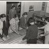In the sewing room, migrant women are instructed in rug-making. Shafter camp for migrants (Farm Security Administration-FSA), California