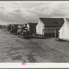 Shafter camp for migrant workers (Farm Security Administration-FSA), California. Tent platforms are supplied. Workers supply their own tents. The newer camps are experimenting with prefabricated steel one-room houses.