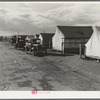 Shafter camp for migrant workers (Farm Security Administration-FSA), California. Tent platforms are supplied. Workers supply their own tents. The newer camps are experimenting with prefabricated steel one-room houses