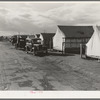 Shafter camp for migrant workers (Farm Security Administration-FSA), California. Tent platforms are supplied. Workers supply their own tents. The newer camps are experimenting with prefabricated steel one-room houses