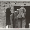 Destitute farm labor families come to Farm Security Administration (FSA) distributing depot to apply for food grant. Kern County, California