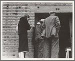 Destitute farm labor families come to Farm Security Administration (FSA) distributing depot to apply for food grant. Kern County, California