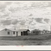 Looking from the camp to adjoining tract where Farm Security Administration (FSA) has just completed forty homes to be occupied by low income workers