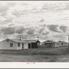 Looking from the camp to adjoining tract where Farm Security Administration (FSA) has just completed forty homes to be occupied by low income workers