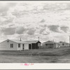 Looking from the camp to adjoining tract where Farm Security Administration (FSA) has just completed forty homes to be occupied by low income workers