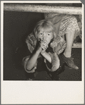 Kern County, California. Undernourished cotton picker's child listening to speeches of organizer at strike meeting to raise wages from seventy-five cents to ninety cents a hundred pounds. Strike unsuccessful