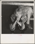 Kern County, California. Undernourished cotton picker's child listening to speeches of organizer at strike meeting to raise wages from seventy-five cents to ninety cents a hundred pounds. Strike unsuccessful