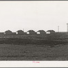 United States government camp for migratory workers (Farm Security Administration-FSA), Westley, California. Pre-fabricated steel shelters replace the use of tents and tent platforms in this newly constructed camp