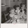 Lunchtime for young migrants at Shafter Camp, California. The nursery school for migrant children is conducted in camp under nursery school teachers trained by WPA (Work Projects Administration), and assigned to work in the camp under (WPA) project
