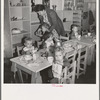 Lunchtime for young migrants at Shafter Camp, California. The nursery school for migrant children is conducted in camp under nursery school teachers trained by WPA (Work Projects Administration), and assigned to work in the camp under (WPA) project