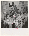 Lunchtime for young migrants at Shafter Camp, California. The nursery school for migrant children is conducted in camp under nursery school teachers trained by WPA (Work Projects Administration), and assigned to work in the camp under (WPA) project