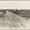 Kern County, California. Camp of two related families seen from U.S. 99. Oil field beyond. Came to California in 1920 from Missouri. Father had job for eight years. Was gang foreman on Los Angeles Aqueduct; laid off two months ago