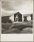 United States government camp for migrants (Farm Security Administration), Farmersville, California. Prefabricated steel dwellings "one step up from a tent" replace the use of tents in the newer California camps