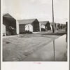 Prefabricated steel dwellings (one step up from a tent) replace the use of a tent in the newer California camps. United States goverment camp for migrants, Farm Security Administration. Farmersville, California