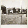 Prefabricated steel dwellings (one step up from a tent) replace the use of a tent in the newer California camps. United States goverment camp for migrants, Farm Security Administration. Farmersville, California