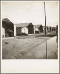 Prefabricated steel dwellings (one step up from a tent) replace the use of a tent in the newer California camps. United States goverment camp for migrants, Farm Security Administration. Farmersville, California