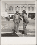 Calipatria, Imperial Valley. Idle pea pickers discuss prospects for work. California