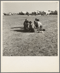 Marble time in Farm Security Administration (FSA) migratory labor camp (emergency). Plenty of space to play and plenty of companions for the children during pea harvest. Near Calipatria, Imperial Valley. California