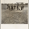 Marble time in Farm Security Administration (FSA) migratory labor camp (emergency.) Plenty of space to play and plenty of companions for the children during pea harvest. Near Calipatria, Imperial Valley, California
