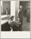 Pea pickers waiting at Farm Security Administration (FSA) office for issue of surplus commodities. Calipatria, California