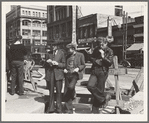 Salvation Army, San Francisco, California. Unemployed young men pause a moment to loiter and watch, and then pass on